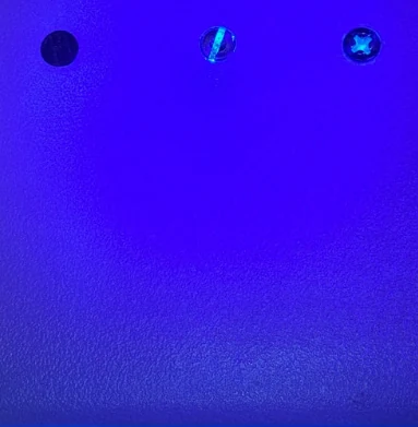 Tracer residue on the three fasteners after wiping