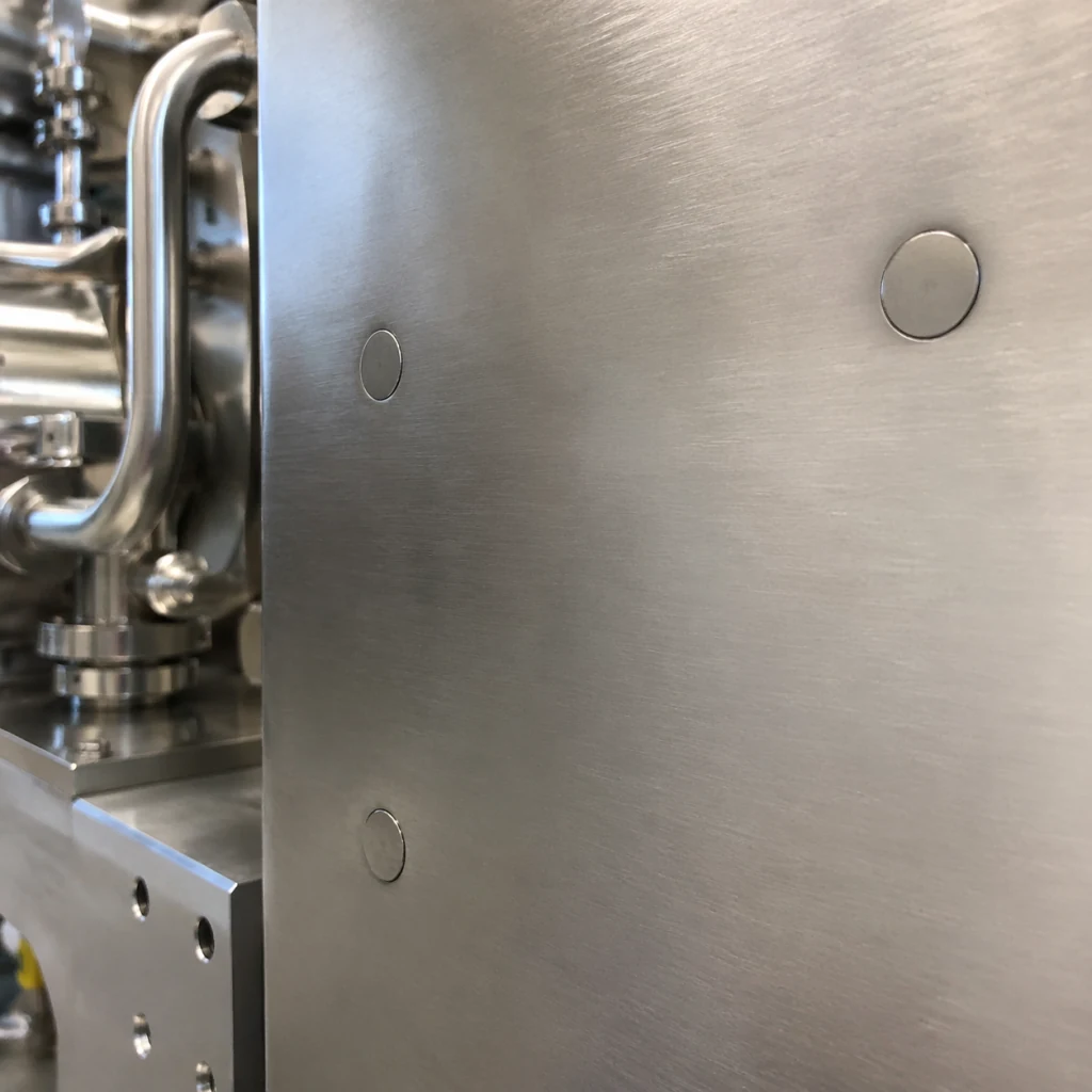 Flush fasteners on an industrial machine panel